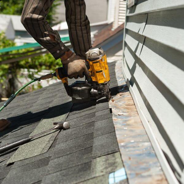 Emergency roof repair in Doncaster with a Roofing Guys Melbourne roofer securing shingles to stop active roof leaks.