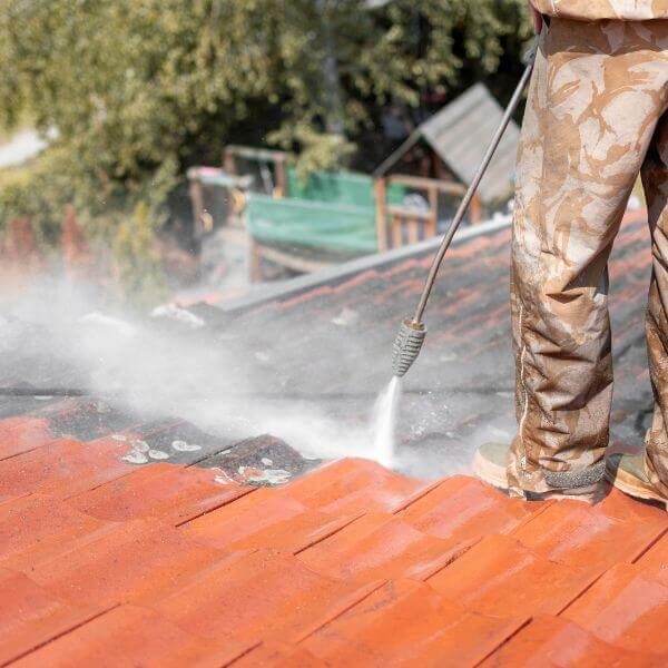 Pressure washing a tiled roof during a full roof restoration by Roofing Guys Melbourne to remove dirt and prep for sealing. Pressure washing a tiled roof during a full roof restoration by Roofing Guys Melbourne to remove dirt and prep for sealing.