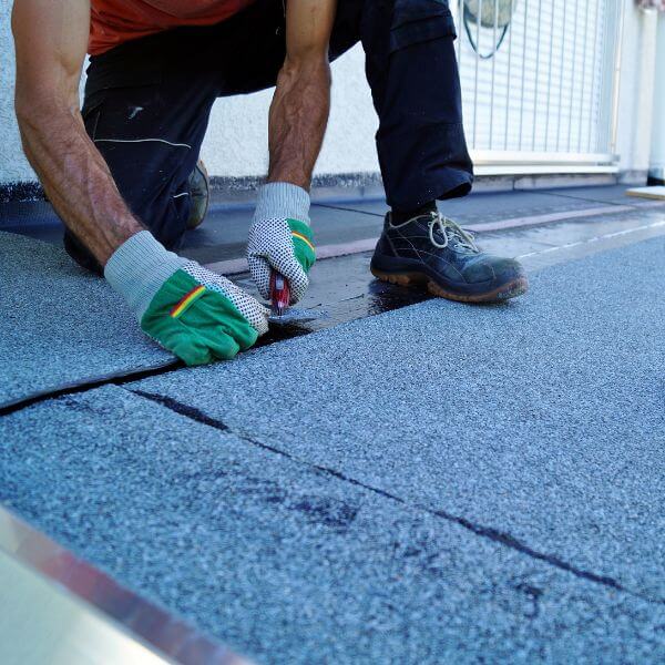 Roofing Guys Melbourne expert sealing a flat commercial roof with bitumen membrane during urgent roof repairs across Melbourne. Roofing Guys Melbourne expert sealing a flat commercial roof with bitumen membrane during urgent roof repairs across Melbourne.