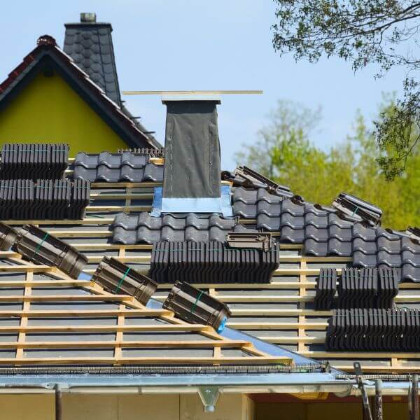 Roofing Guys Melbourne installing a new tiled roof with battens, stacked tiles, and chimney flashing underway on a residential project. Roofing Guys Melbourne installing a new tiled roof with battens, stacked tiles, and chimney flashing underway on a residential project.