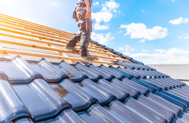 Roofing Guys Melbourne installing new terracotta tiles during a full roof repair and restoration. Roofing Guys Melbourne installing new terracotta tiles during a full roof repair and restoration.