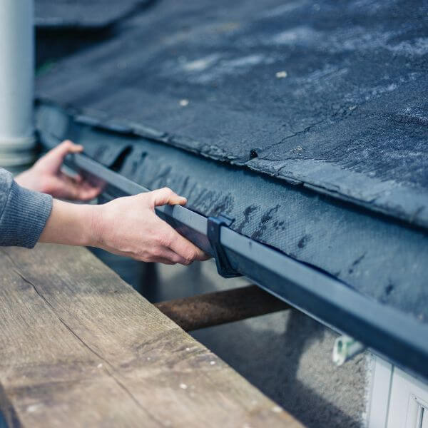 Roofing Guys Melbourne technician repairing a residential gutter to fix drainage issues and protect the fascia from water damage. Roofing Guys Melbourne technician repairing a residential gutter to fix drainage issues and protect the fascia from water damage.