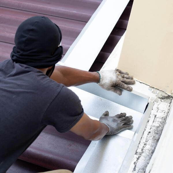 Roofing Guys Melbourne technician repairing roof flashing as part of scheduled residential roof maintenance. Roofing Guys Melbourne technician repairing roof flashing as part of scheduled residential roof maintenance.