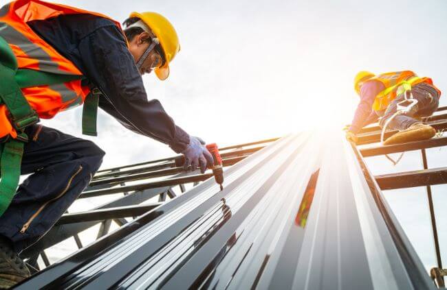 Roofing specialists installing metal roofing panels as part of a full replacement project handled by Roofing Guys Melbourne.