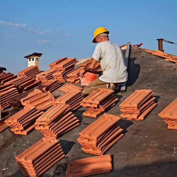 Tile re-roof in Doncaster underway as a roofer from Roofing Guys Melbourne prepares to install new terracotta tiles on a home.