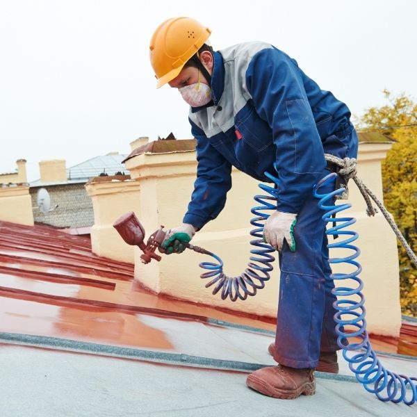 Roofing Guys Melbourne applying protective coatings to tiled roofs for enhanced durability and street appeal.