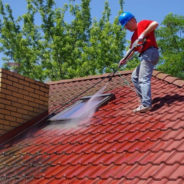 Roofing Guys Melbourne team carrying out roof cleaning in Melbourne removing moss dirt and debris to improve drainage and extend roof life.